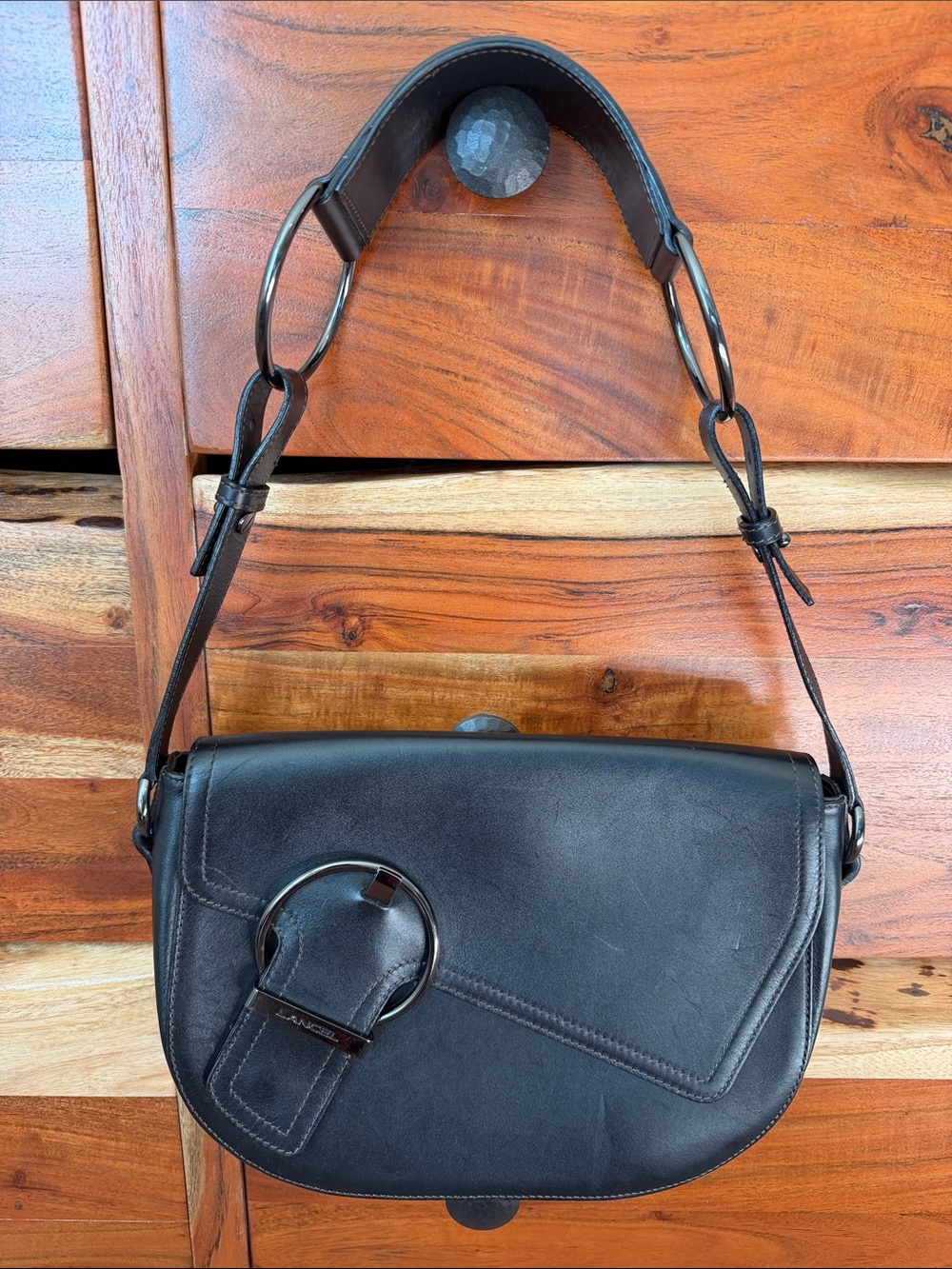 Lancel Black Leather Shoulder Bag with Ring Accents.